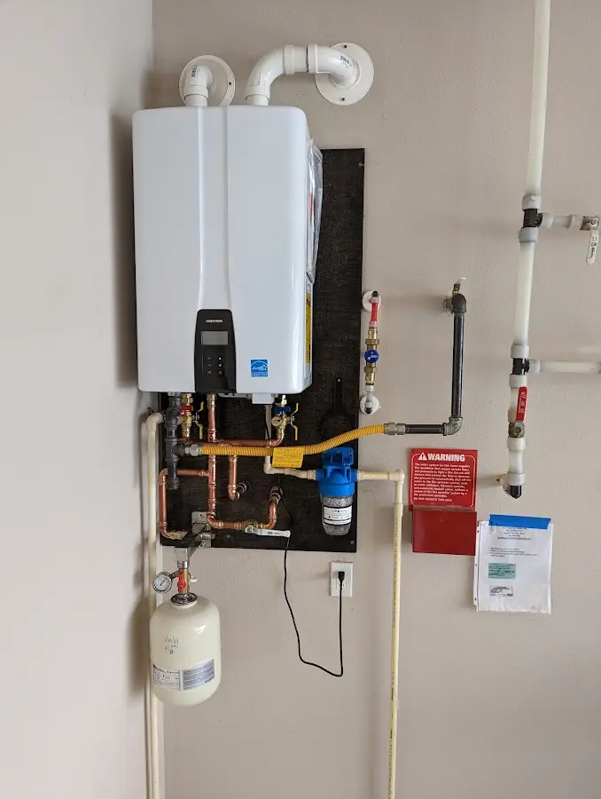 Professional plumber installing copper piping in a Waterbury home